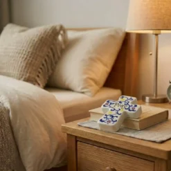 Ceramic wall cross decor above bed