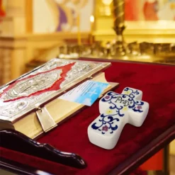 Holding porcelain cross for prayer