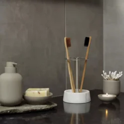 Modern 4-slot toothbrush holder with white marble base and stainless steel stand