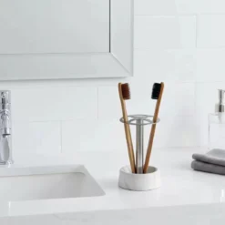 Modern 4-slot toothbrush holder with white marble base and stainless steel stand