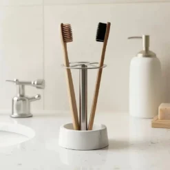 Modern 4-slot toothbrush holder with white marble base and stainless steel stand